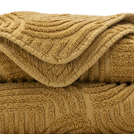 Close-up of a textured gold blanket with intricate patterns.