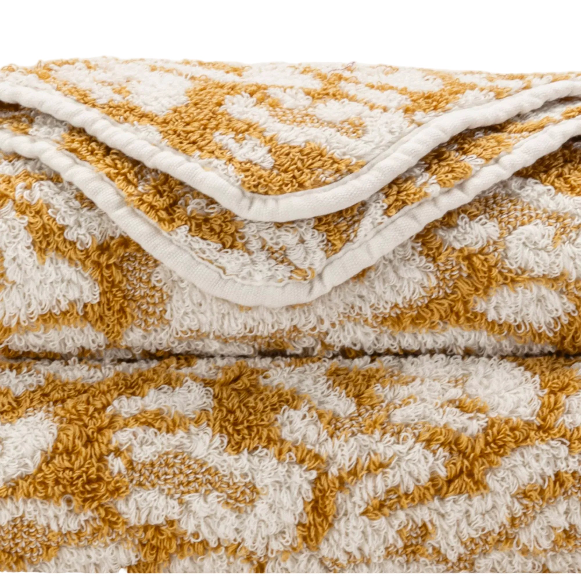 Folded textured blanket with a geometric pattern on a white background