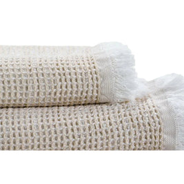 Two beige textured towels on a white background